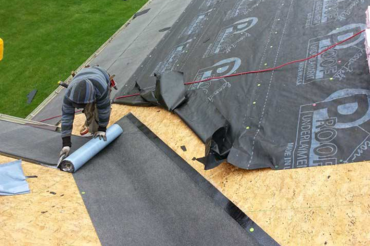 Action Roofing team performing summer maintenance on a residential roof in Des Moines.