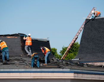 Professional roofing team from Action Roofing working on a Johnston roof repair.