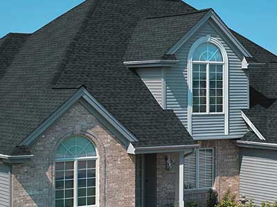 Home with a new GAF asphalt shingle roof by Action Roofing