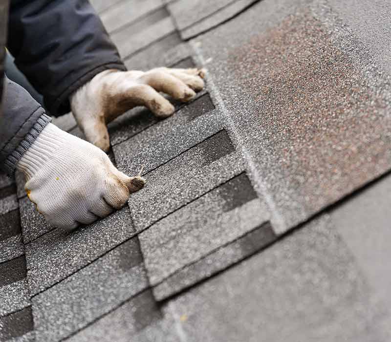 Action Roofing crew installing shingles on an Ankeny-area home